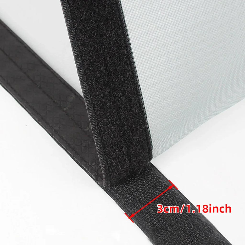 Close-up of a screen door mesh with black 3cm wide Velcro tape, measured for installation