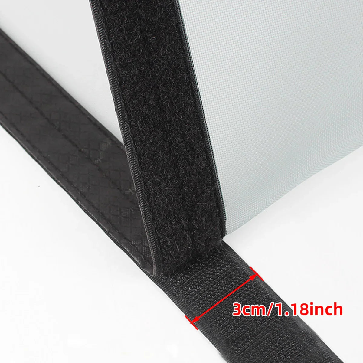 Close-up of a screen door mesh with black 3cm wide Velcro tape, measured for installation