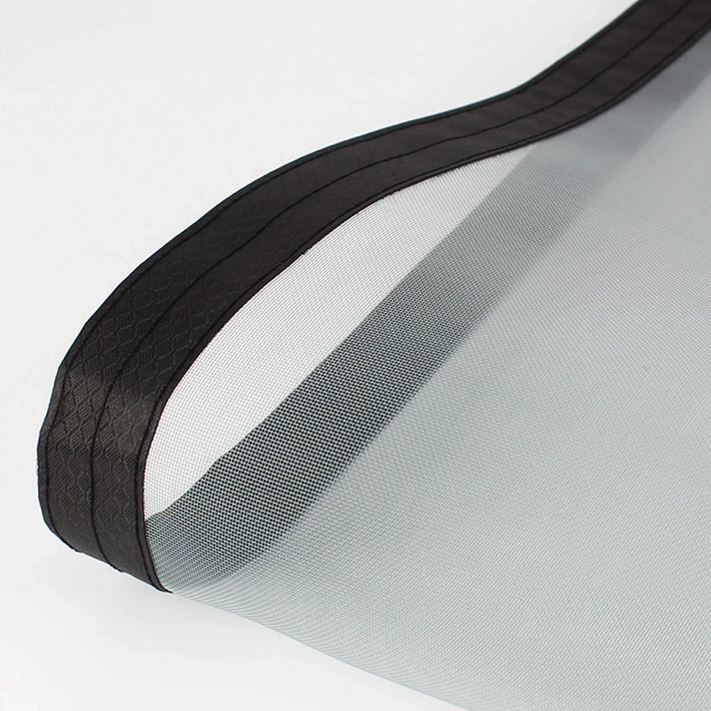 close-up of a fine mesh screen door material with a black reinforced edge